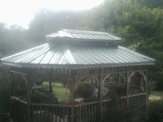 Two tier green metal roof on a garden gazebo in Mooresboro